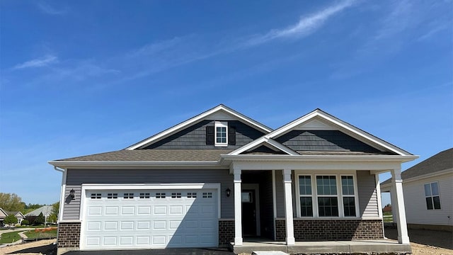2520 Redwood Trl, Wonder Lake, IL 60097 - view of front of home featuring brick siding, a porch, an attached garage, and driveway