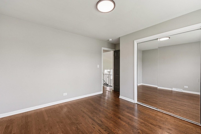 329 E Jefferson St, Bensenville, IL 60106 - unfurnished bedroom with wood finished floors, a closet, and baseboards