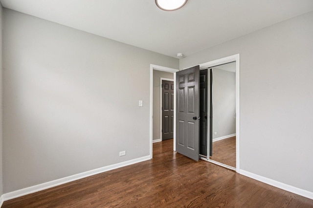 329 E Jefferson St, Bensenville, IL 60106 - unfurnished bedroom with a closet, dark wood-style flooring, and baseboards