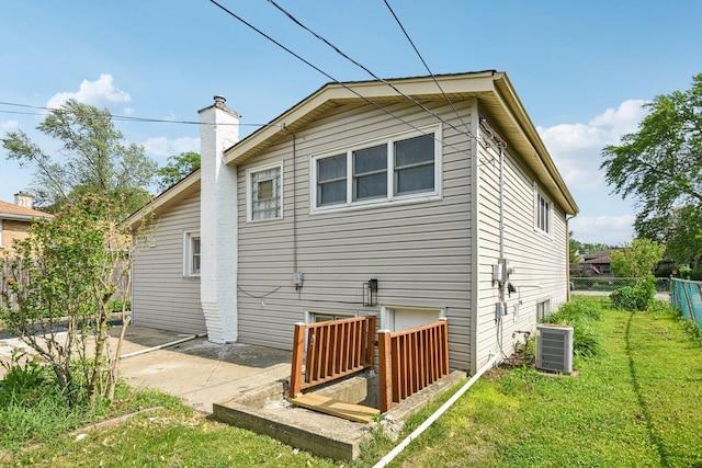 329 E Jefferson St, Bensenville, IL 60106 - rear view of house with a chimney, a patio area, and cooling unit