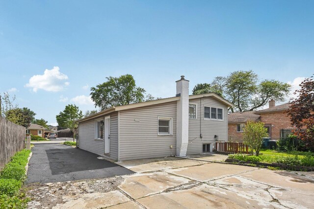 329 E Jefferson St, Bensenville, IL 60106 - back of property with a patio area and a chimney