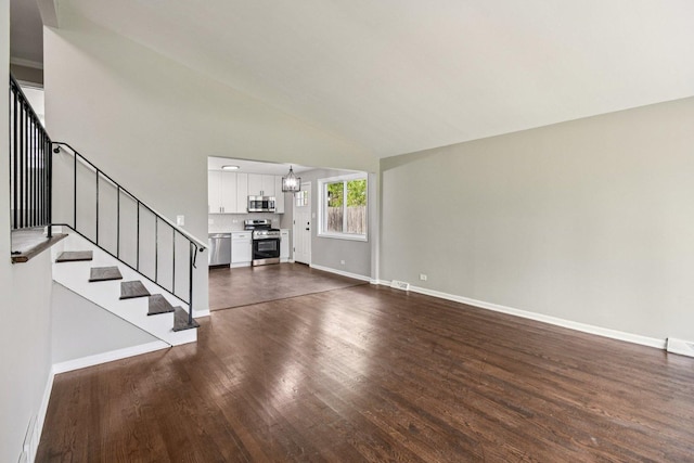 329 E Jefferson St, Bensenville, IL 60106 - unfurnished living room with dark wood-style floors, stairs, baseboards, and high vaulted ceiling