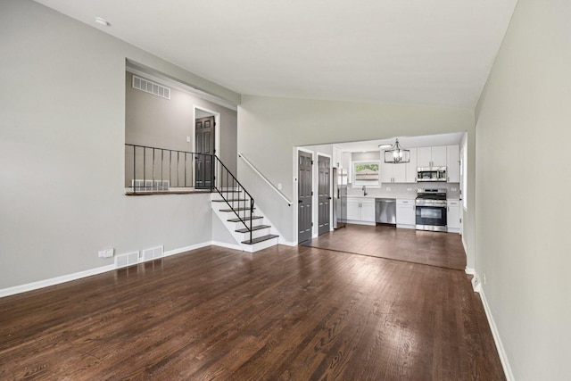 329 E Jefferson St, Bensenville, IL 60106 - unfurnished living room with dark wood finished floors, a chandelier, stairs, lofted ceiling, and baseboards
