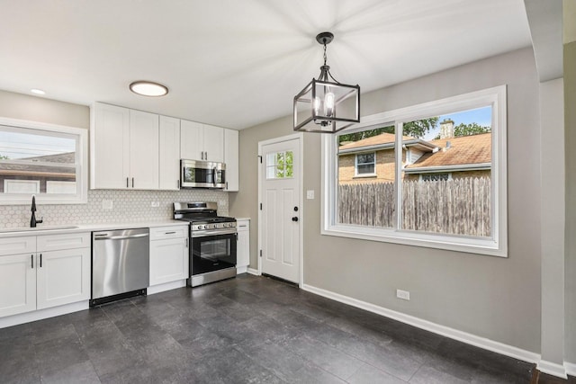 329 E Jefferson St, Bensenville, IL 60106 - kitchen with appliances with stainless steel finishes, a sink, healthy amount of natural light, and a chandelier