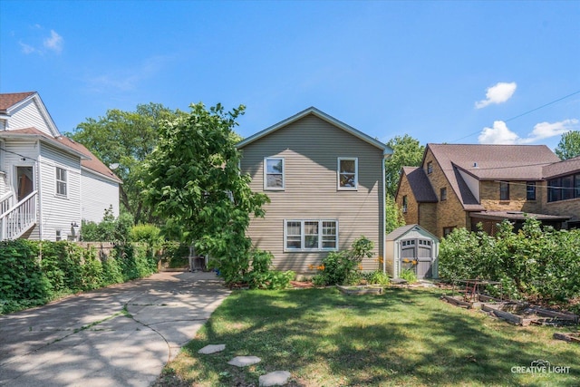 1044 Garfield Ave, Aurora, IL 60506 - view of front facade featuring a storage shed, a front yard, and concrete driveway