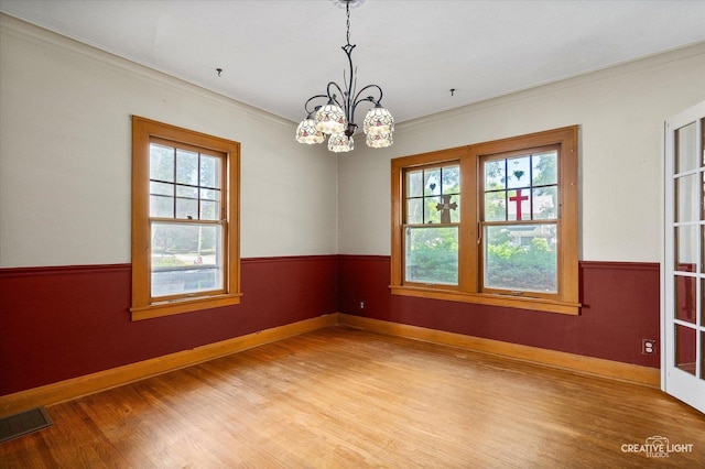 1044 Garfield Ave, Aurora, IL 60506 - spare room featuring light wood-type flooring, a chandelier, and crown molding