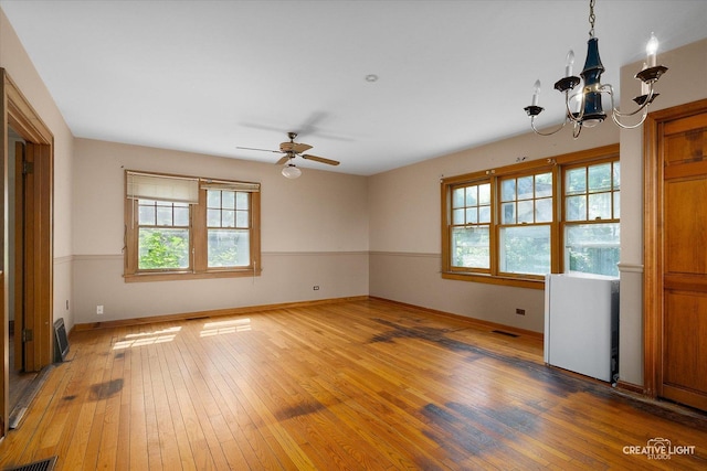 1044 Garfield Ave, Aurora, IL 60506 - unfurnished room featuring a chandelier, plenty of natural light, and light wood finished floors