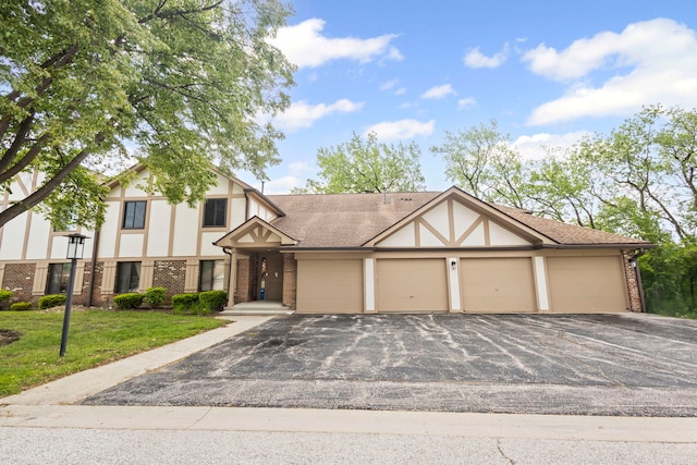 913 Knottingham Dr Unit 2A, Schaumburg, IL 60193 - tudor home featuring brick siding, driveway, an attached garage, and stucco siding