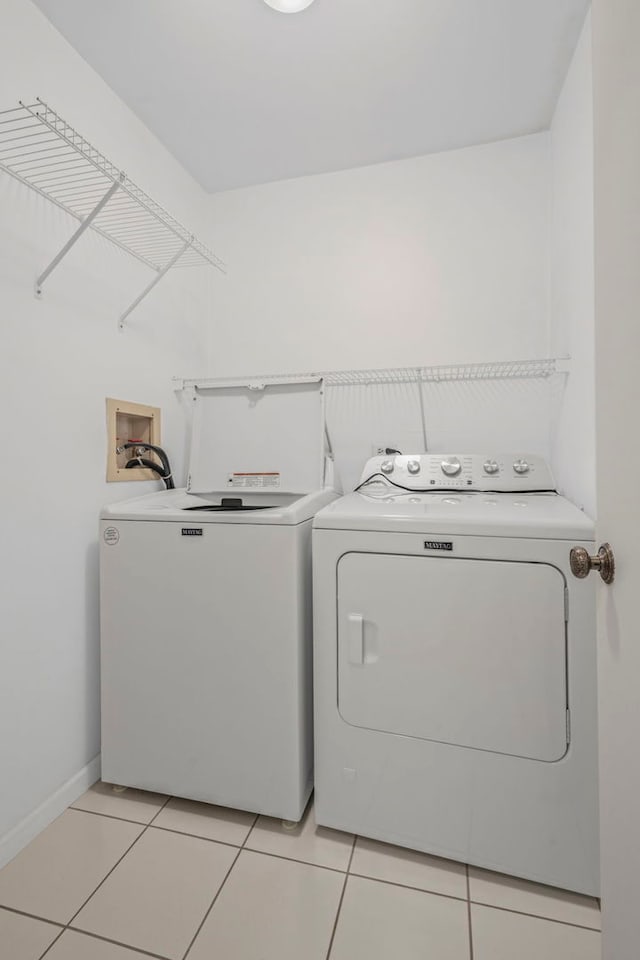 913 Knottingham Dr Unit 2A, Schaumburg, IL 60193 - laundry room with separate washer and dryer, light tile patterned flooring, and baseboards