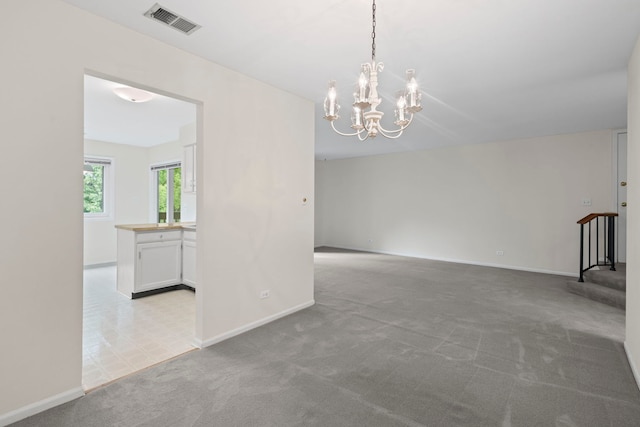913 Knottingham Dr Unit 2A, Schaumburg, IL 60193 - carpeted empty room with a chandelier, baseboards, and stairway