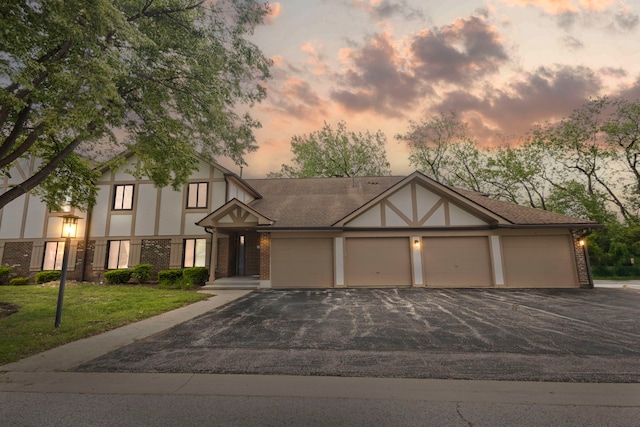 913 Knottingham Dr Unit 2A, Schaumburg, IL 60193 - tudor-style house featuring brick siding, driveway, stucco siding, and a front yard