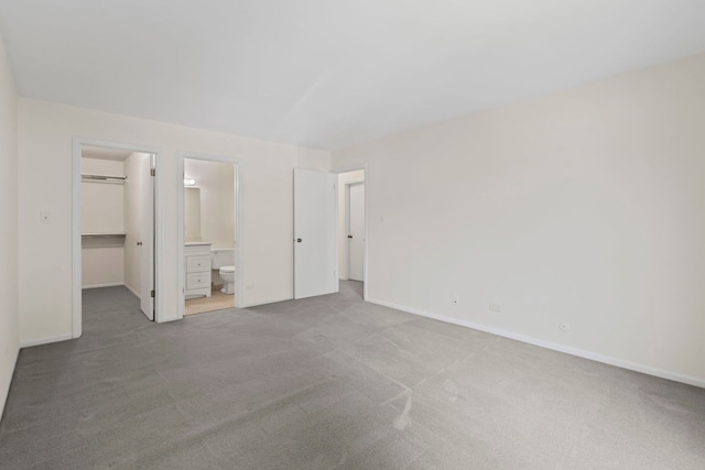 913 Knottingham Dr Unit 2A, Schaumburg, IL 60193 - unfurnished bedroom featuring a walk in closet, carpet flooring, baseboards, and a closet