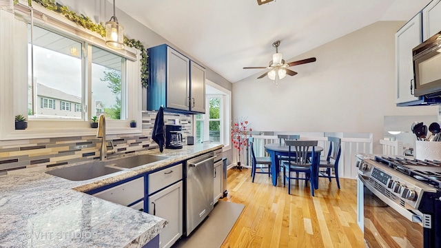 1176 Westport Rdg, Crystal Lake, IL 60014 - kitchen featuring appliances with stainless steel finishes, a sink, lofted ceiling, tasteful backsplash, and ceiling fan