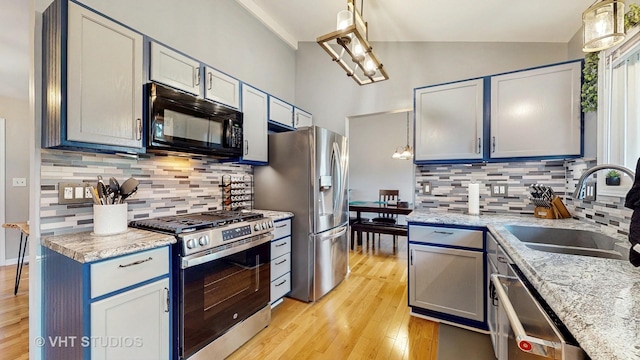 1176 Westport Rdg, Crystal Lake, IL 60014 - kitchen featuring appliances with stainless steel finishes, a sink, light wood-style floors, tasteful backsplash, and high vaulted ceiling