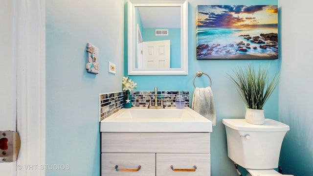 1176 Westport Rdg, Crystal Lake, IL 60014 - bathroom featuring vanity, toilet, and decorative backsplash