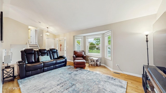 1176 Westport Rdg, Crystal Lake, IL 60014 - living area featuring vaulted ceiling, stairway, light wood-style flooring, baseboards, and a chandelier
