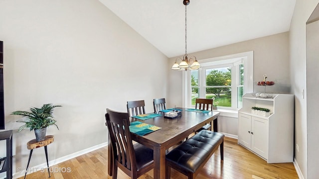 1176 Westport Rdg, Crystal Lake, IL 60014 - dining area featuring light wood-style flooring, lofted ceiling, a chandelier, and baseboards