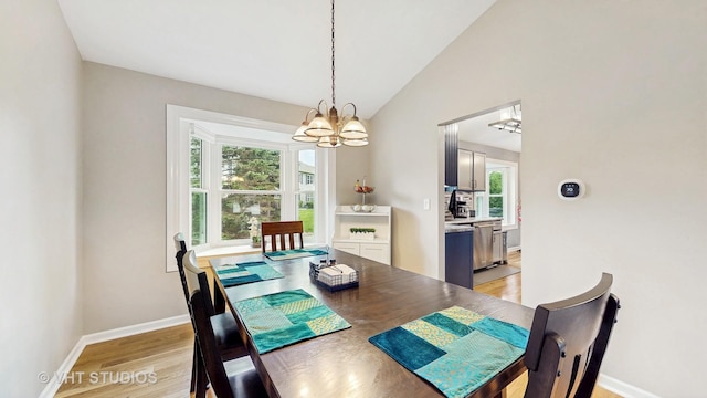 1176 Westport Rdg, Crystal Lake, IL 60014 - dining space with a chandelier, healthy amount of natural light, baseboards, light wood-style flooring, and vaulted ceiling