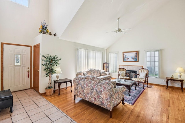 3410 Beckwith Ln, Crete, IL 60417 - living room with high vaulted ceiling, ceiling fan, light wood-style flooring, and a fireplace