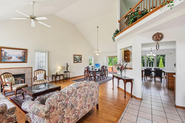 3410 Beckwith Ln, Crete, IL 60417 - living room featuring a chandelier, high vaulted ceiling, a fireplace, ceiling fan, and light tile patterned floors