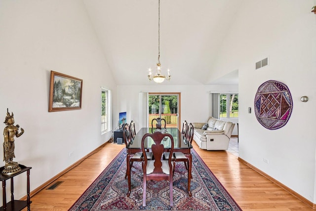 3410 Beckwith Ln, Crete, IL 60417 - dining area featuring light wood-style floors, a chandelier, and high vaulted ceiling