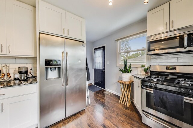 1086 E Thacker St, Des Plaines, IL 60016 - kitchen featuring stainless steel appliances, dark stone countertops, dark wood-style flooring, and white cabinets