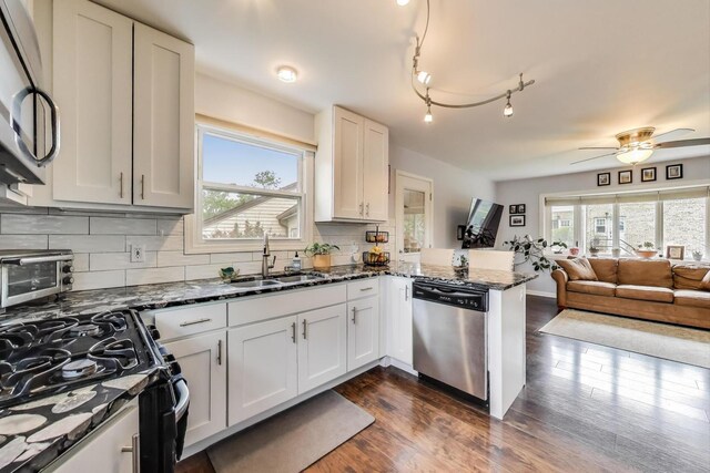 1086 E Thacker St, Des Plaines, IL 60016 - kitchen featuring stainless steel dishwasher, a sink, gas stove, open floor plan, and a peninsula