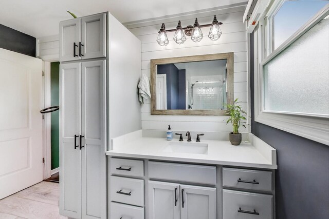 1086 E Thacker St, Des Plaines, IL 60016 - full bath with healthy amount of natural light, vanity, a shower stall, and wood finished floors