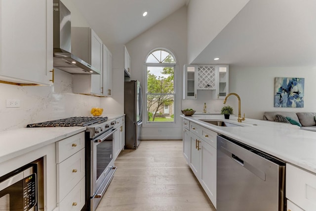 13045 Silver Fox Dr, Lemont, IL 60439 - kitchen with wall chimney range hood, stainless steel appliances, a sink, light wood finished floors, and vaulted ceiling