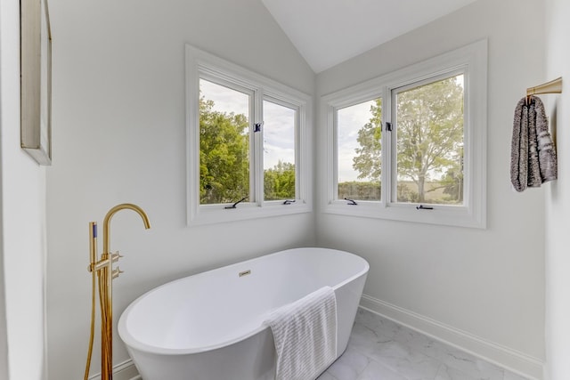 13045 Silver Fox Dr, Lemont, IL 60439 - full bathroom with marble finish flooring, a freestanding tub, lofted ceiling, and baseboards