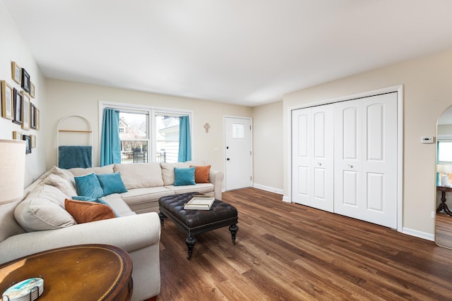 208 N Fremont St, Naperville, IL 60540 - living area featuring dark wood finished floors, healthy amount of natural light, baseboards, and arched walkways