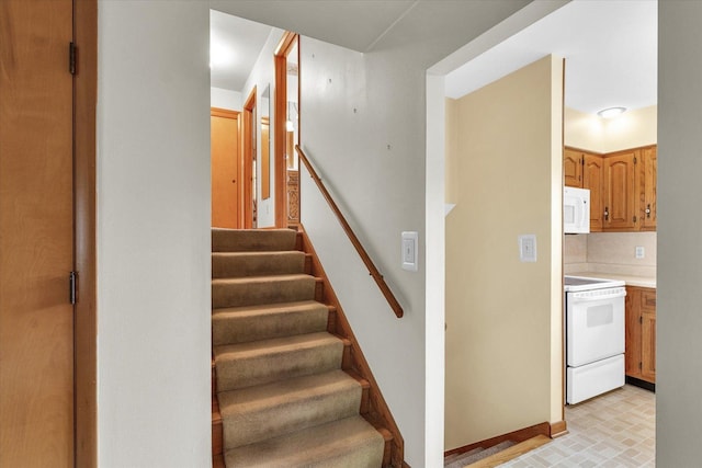404 Maple Ln, Monticello, IL 61856 - stairway featuring baseboards and brick patterned floors