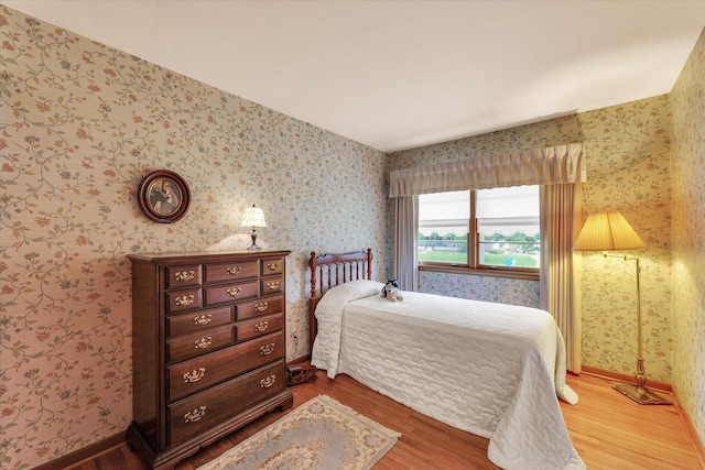 404 Maple Ln, Monticello, IL 61856 - bedroom with wood finished floors and wallpapered walls