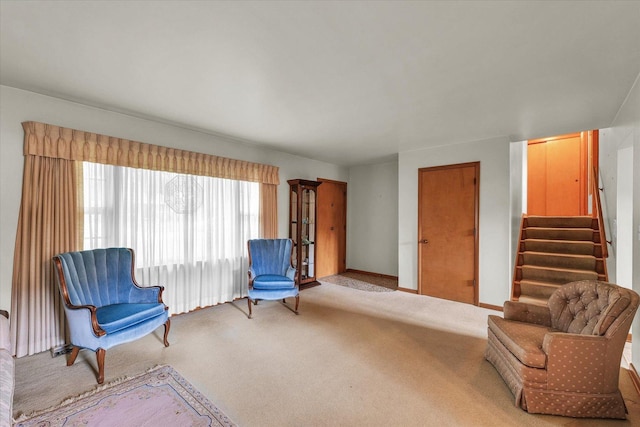 404 Maple Ln, Monticello, IL 61856 - sitting room featuring carpet floors, stairway, and baseboards
