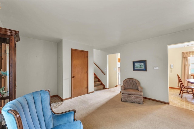 404 Maple Ln, Monticello, IL 61856 - living area with carpet, stairway, and baseboards