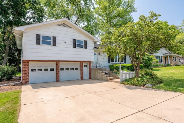 408 E Fabyan Pkwy, Batavia, IL 60510 - split level home featuring brick siding, a garage, concrete driveway, and a front lawn