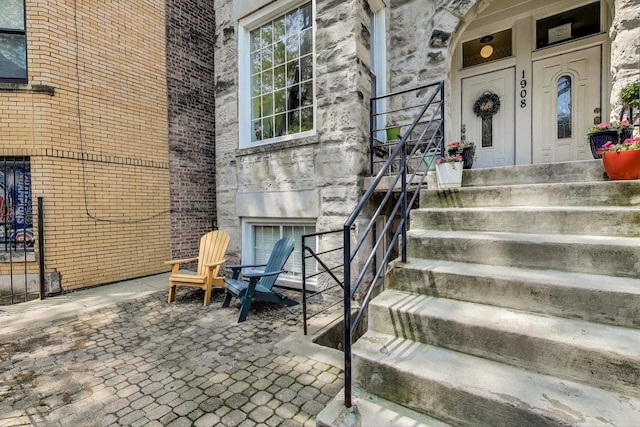 1908 N Whipple St Unit 2, Chicago, IL 60647 - view of exterior entry with a fireplace, brick siding, and stone siding