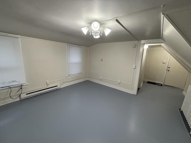 572 Walnut Ave, Elgin, IL 60123 - additional living space with a baseboard heating unit, finished concrete flooring, and vaulted ceiling
