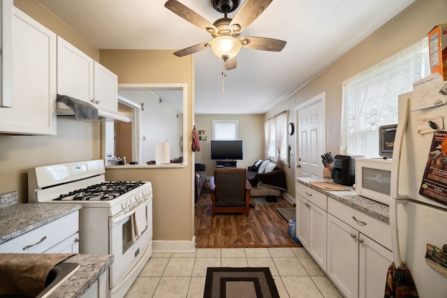 572 Walnut Ave, Elgin, IL 60123 - kitchen with white appliances, light tile patterned floors, white cabinetry, a ceiling fan, and under cabinet range hood