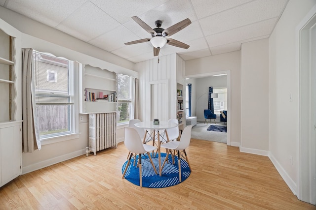 572 Walnut Ave, Elgin, IL 60123 - dining area with wood finished floors, a drop ceiling, radiator, baseboards, and a ceiling fan