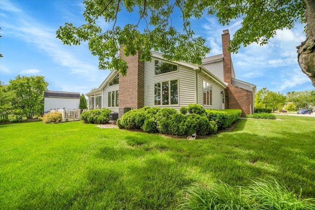 731 Viola Ct, Schaumburg, IL 60194 - view of property exterior featuring a chimney and a lawn