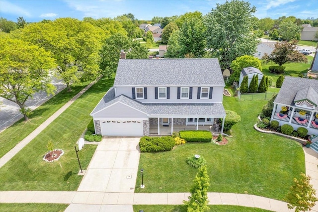 731 Viola Ct, Schaumburg, IL 60194 - view of front facade with a porch, driveway, a chimney, stone siding, and a front yard