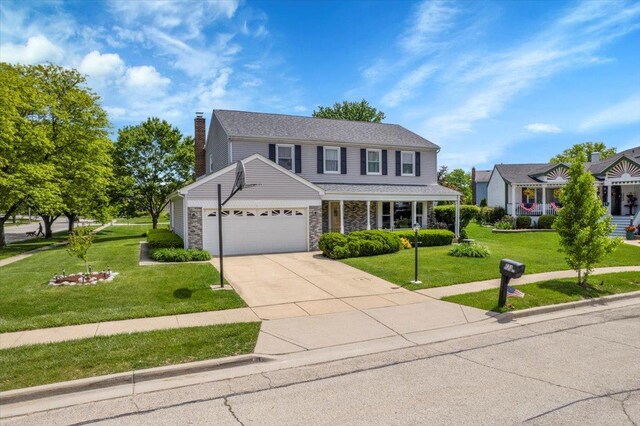 731 Viola Ct, Schaumburg, IL 60194 - traditional-style house with a garage, stone siding, a front yard, a chimney, and driveway
