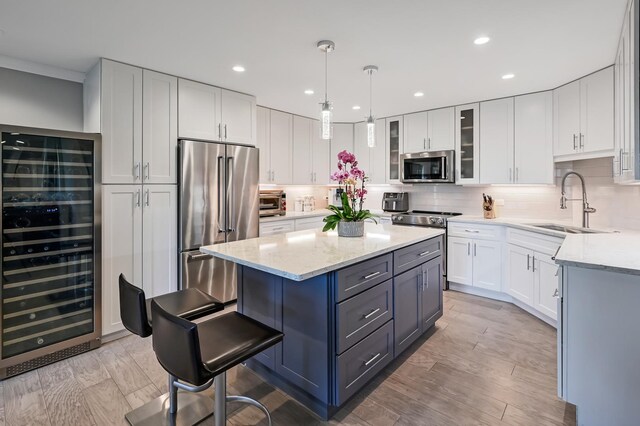 1409 Burr Oak Rd Unit 311A, Hinsdale, IL 60521 - kitchen with beverage cooler, stainless steel appliances, white cabinetry, a kitchen island, and tasteful backsplash