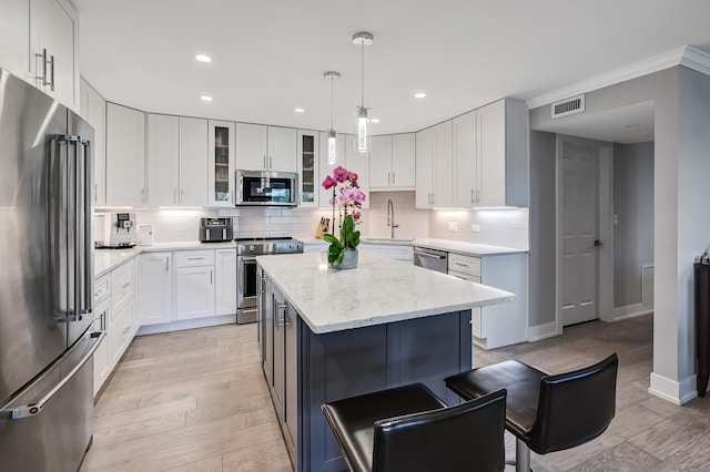1409 Burr Oak Rd Unit 311A, Hinsdale, IL 60521 - kitchen with appliances with stainless steel finishes, backsplash, recessed lighting, light stone counters, and white cabinets