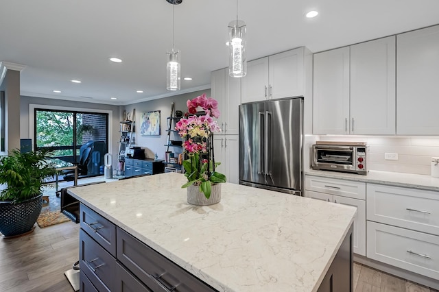 1409 Burr Oak Rd Unit 311A, Hinsdale, IL 60521 - kitchen featuring high end refrigerator, a center island, light wood finished floors, white cabinets, and crown molding