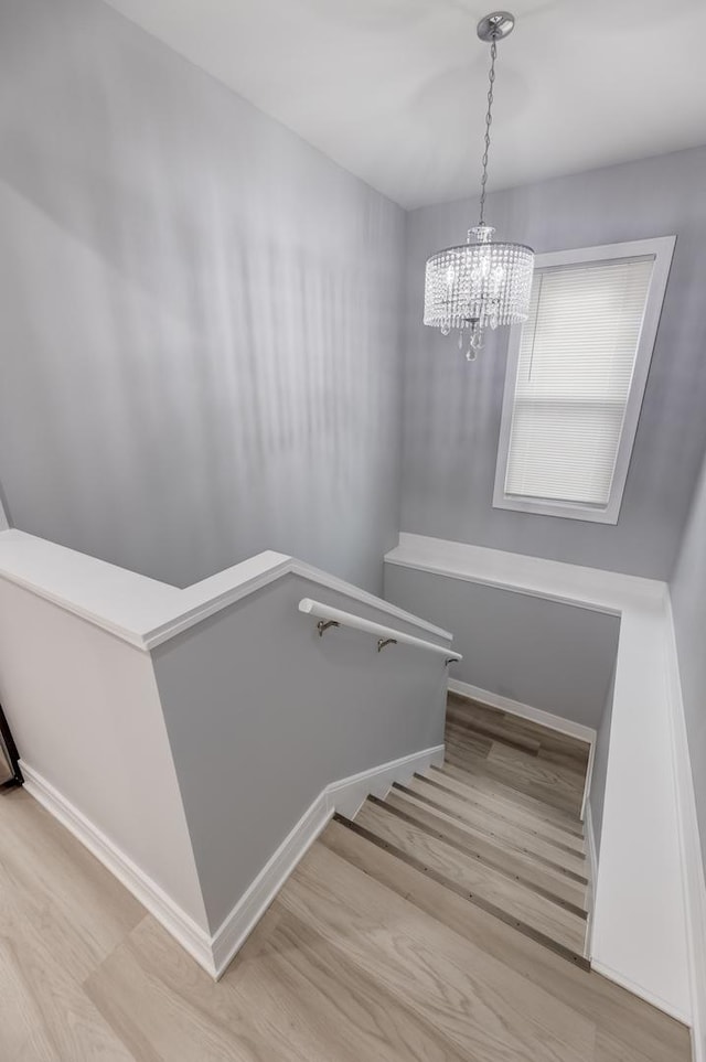 5731 S Damen Ave, Chicago, IL 60636 - staircase with wood finished floors, a chandelier, and baseboards