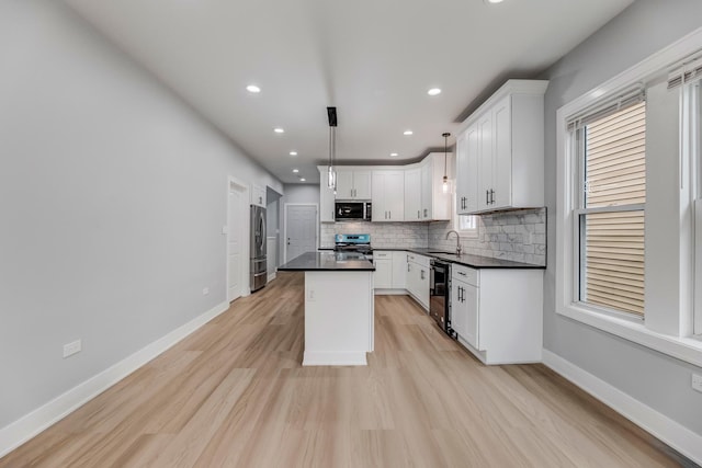 5731 S Damen Ave, Chicago, IL 60636 - kitchen with appliances with stainless steel finishes, dark countertops, a kitchen island, a sink, and backsplash