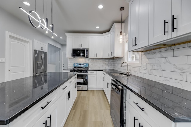 5731 S Damen Ave, Chicago, IL 60636 - kitchen featuring appliances with stainless steel finishes, a sink, white cabinetry, decorative backsplash, and recessed lighting