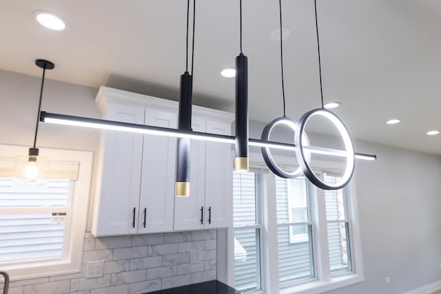 5731 S Damen Ave, Chicago, IL 60636 - kitchen view of white cabinets, decorative backsplash, and recessed lighting